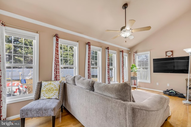 living area with ceiling fan, plenty of natural light, lofted ceiling, and wood finished floors