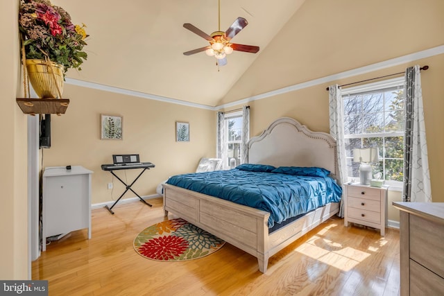 bedroom featuring light wood-style flooring, a ceiling fan, baseboards, and high vaulted ceiling