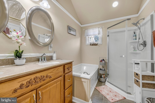 full bath with vanity, tile patterned flooring, vaulted ceiling, a shower stall, and a bath