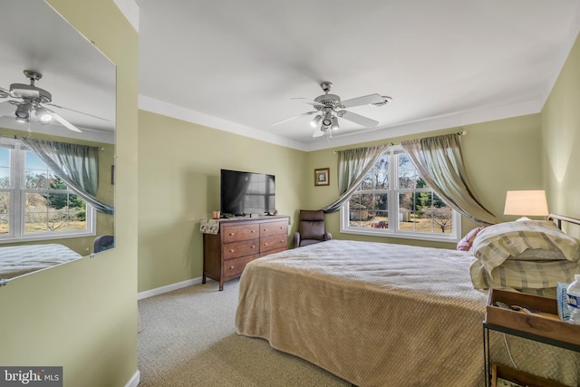 bedroom with ornamental molding, a ceiling fan, baseboards, and light carpet