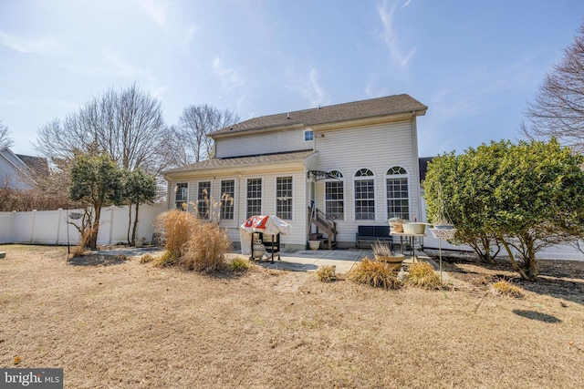 back of house featuring entry steps, a patio, and fence