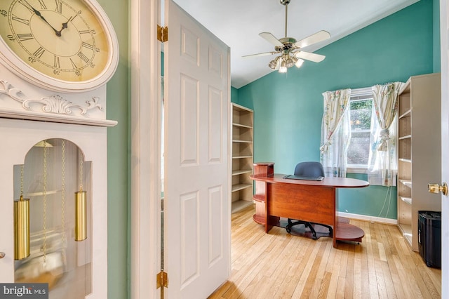 office with baseboards, wood-type flooring, and a ceiling fan