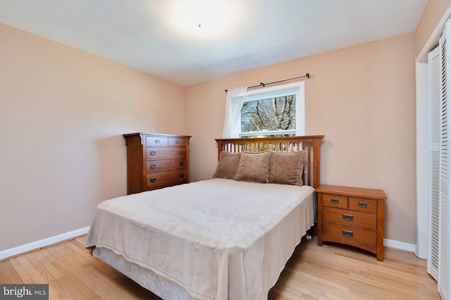 bedroom with light wood-type flooring and baseboards