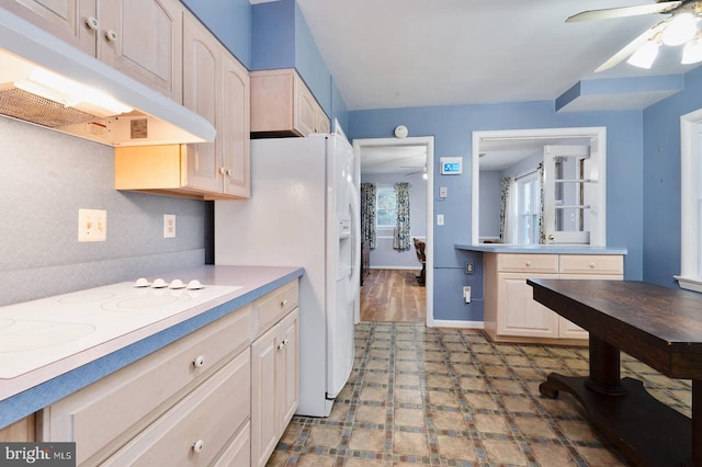 kitchen featuring tile patterned floors, a ceiling fan, under cabinet range hood, white appliances, and light countertops