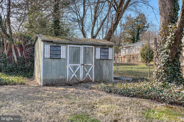 view of shed with fence