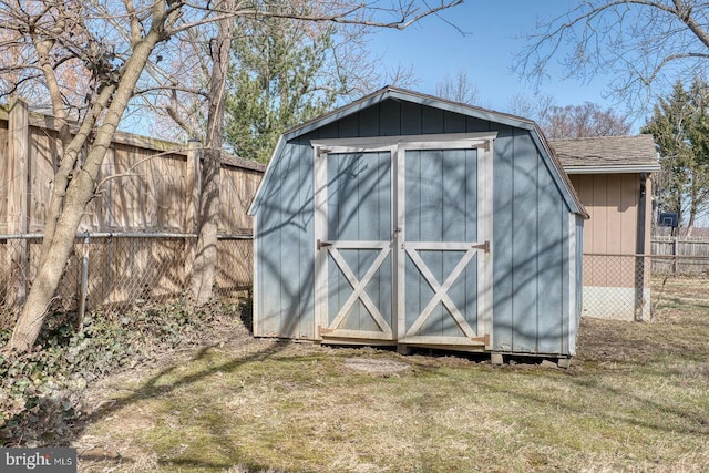 view of shed featuring fence