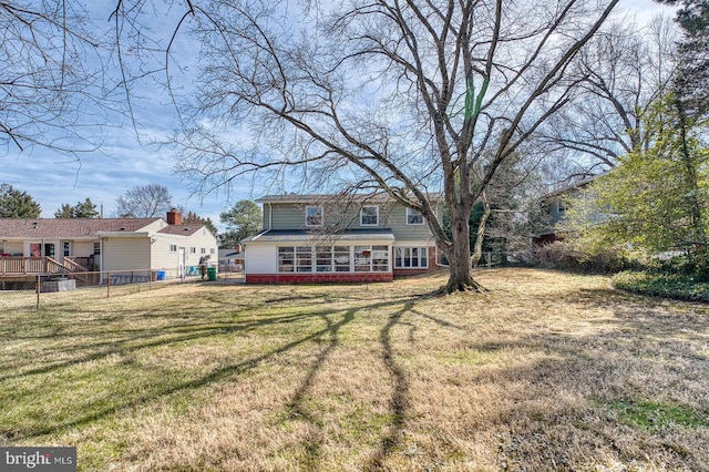 back of house with a yard and fence