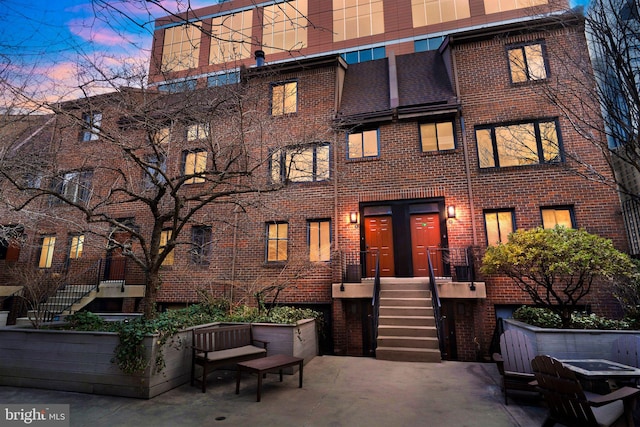 exterior space featuring brick siding