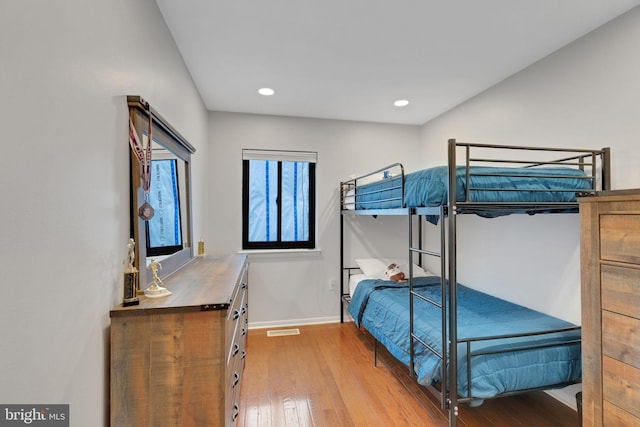 bedroom featuring recessed lighting, light wood-type flooring, baseboards, and visible vents