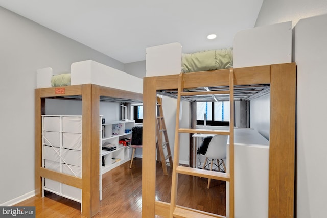 bedroom featuring baseboards and wood finished floors