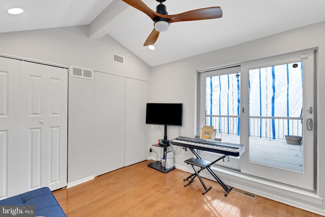 playroom with lofted ceiling with beams, visible vents, and light wood-style flooring