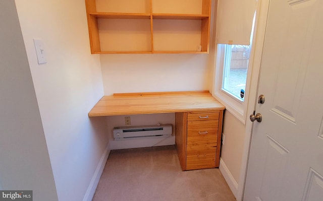 unfurnished office featuring baseboard heating, light colored carpet, and baseboards