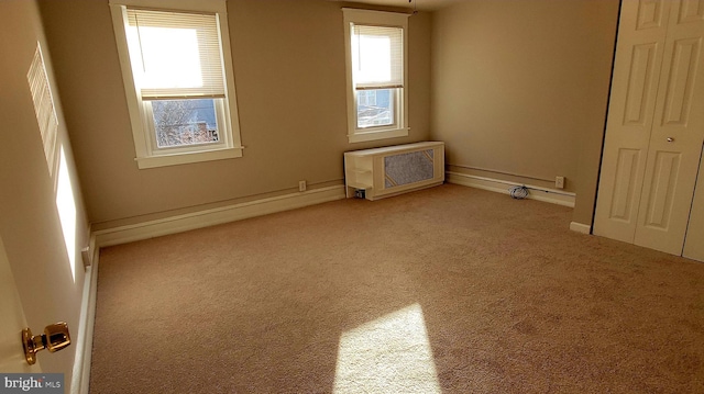 spare room featuring light colored carpet