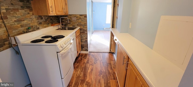 kitchen with dark wood-type flooring, light countertops, decorative backsplash, electric stove, and a sink