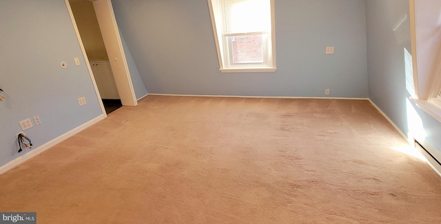 carpeted spare room featuring baseboards