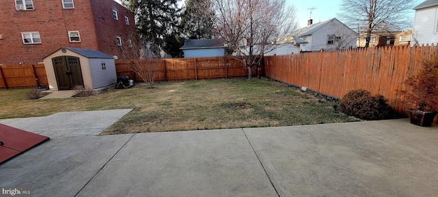 view of yard featuring a fenced backyard, a patio, an outdoor structure, and a shed