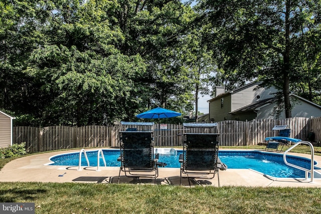 view of swimming pool featuring a fenced backyard and a fenced in pool