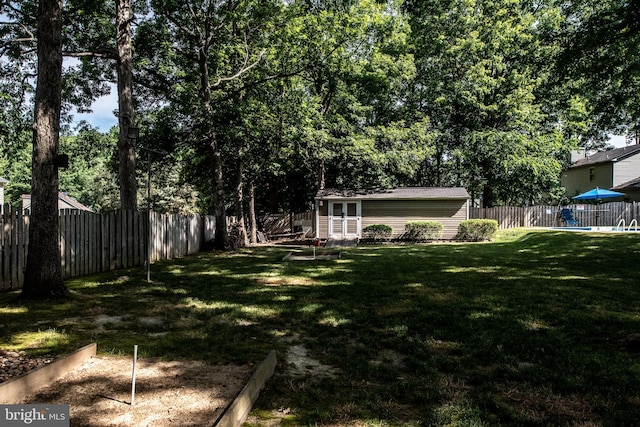 view of yard featuring an outbuilding and a fenced backyard