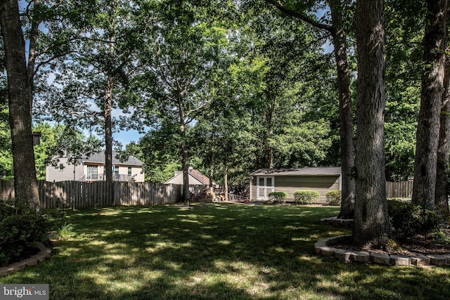 view of yard featuring an outdoor structure and fence