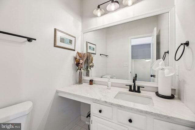 half bathroom featuring toilet and vanity