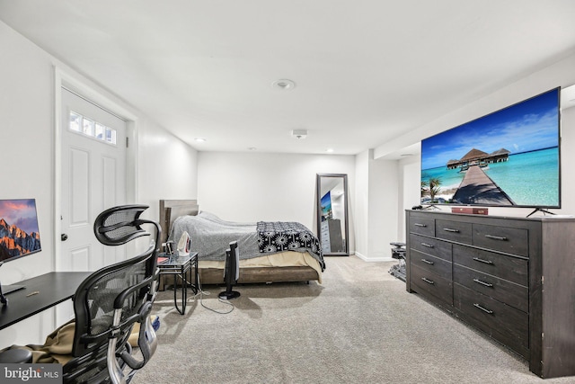 bedroom featuring light colored carpet and baseboards