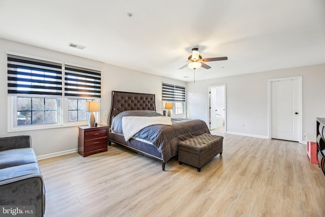 bedroom featuring visible vents, baseboards, light wood-style floors, and a ceiling fan