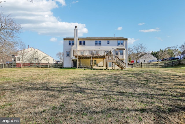 rear view of house with stairway, a wooden deck, a fenced backyard, a chimney, and a lawn