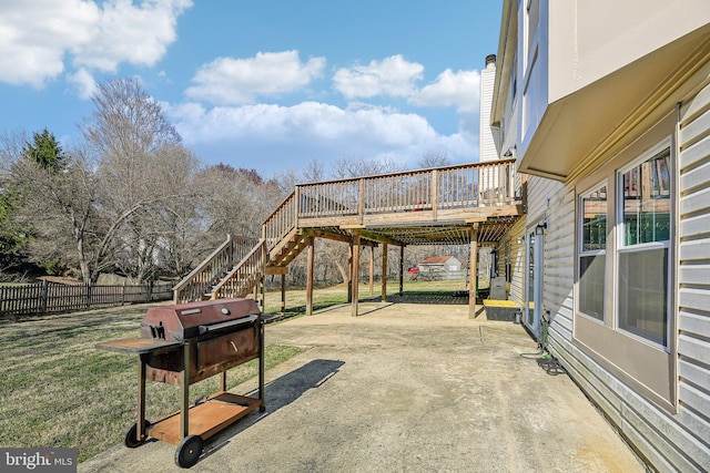 view of patio / terrace featuring a wooden deck, stairway, a grill, and fence