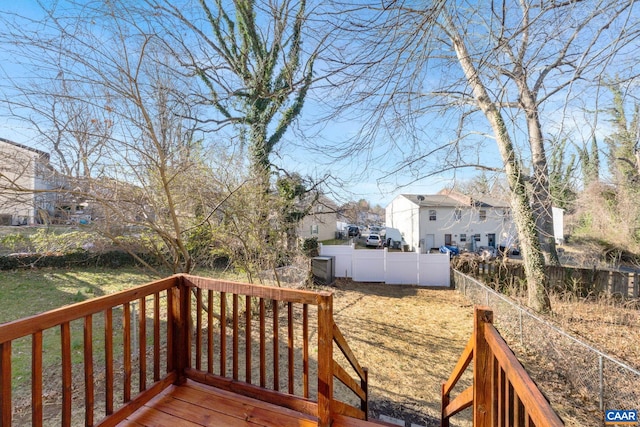 wooden terrace featuring a residential view and fence