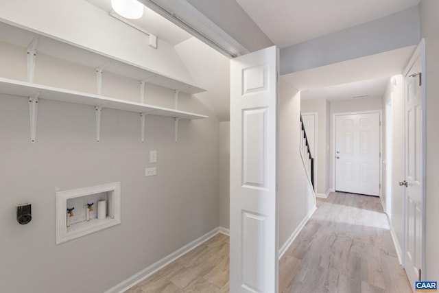 clothes washing area with baseboards, hookup for an electric dryer, washer hookup, and laundry area