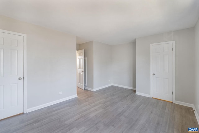 empty room featuring baseboards and wood finished floors