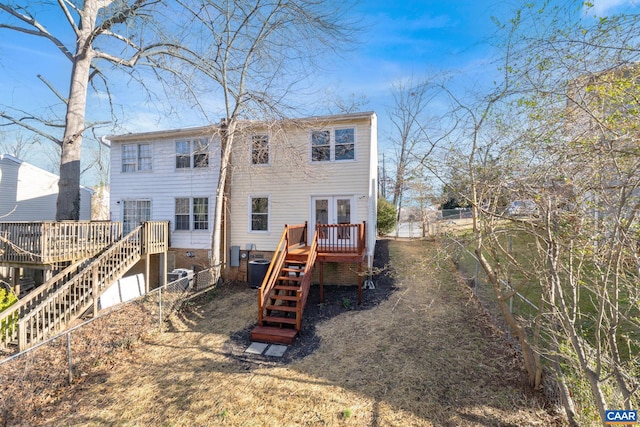 back of property with stairway, a deck, and french doors