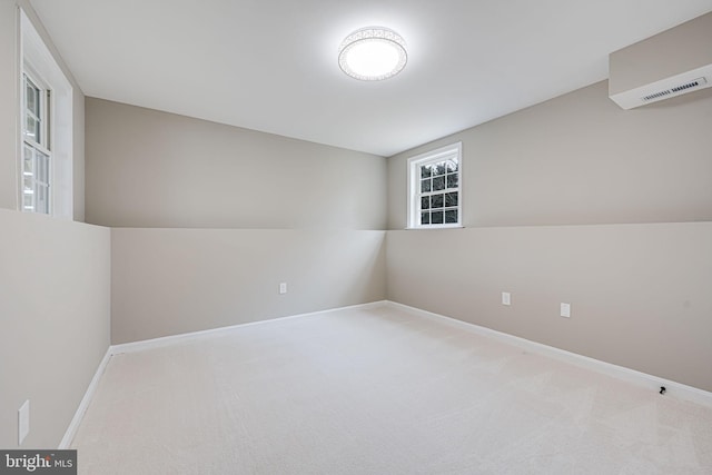 carpeted empty room featuring baseboards