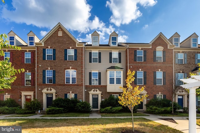 view of property featuring brick siding