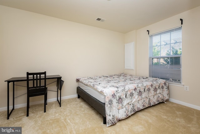 carpeted bedroom with visible vents and baseboards