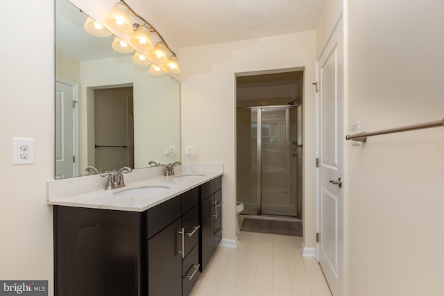 bathroom featuring a sink, double vanity, and a shower stall