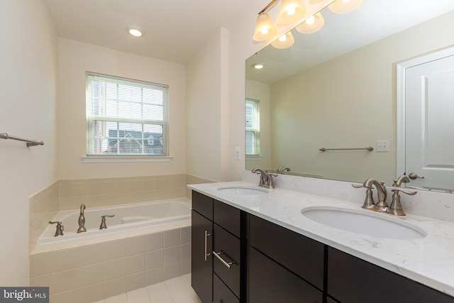 full bath with double vanity, a bath, recessed lighting, and a sink