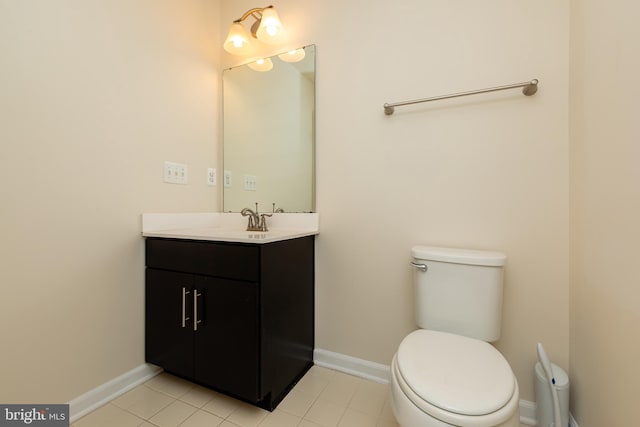 bathroom with vanity, tile patterned floors, toilet, and baseboards