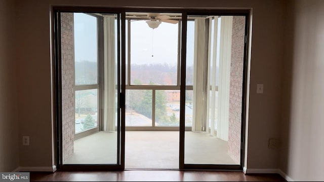 entryway with baseboards and a ceiling fan