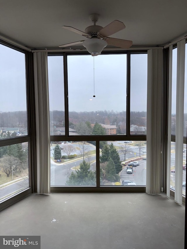 interior space featuring finished concrete flooring and a ceiling fan