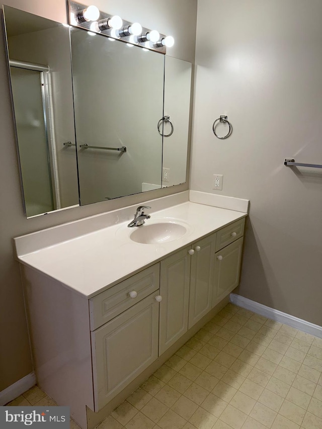 bathroom featuring vanity and baseboards