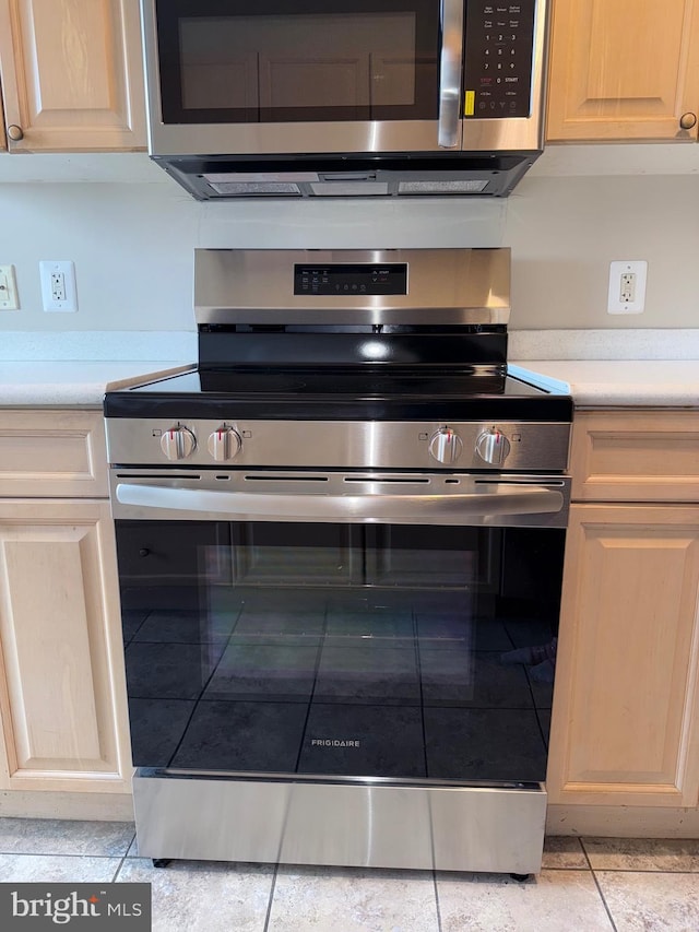 kitchen with appliances with stainless steel finishes and light countertops