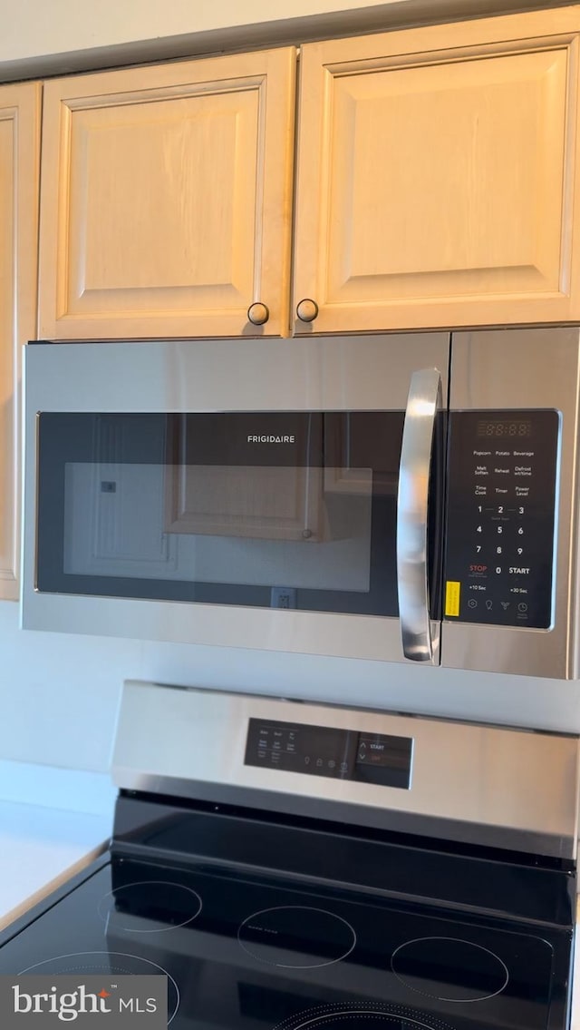 room details featuring appliances with stainless steel finishes and light countertops