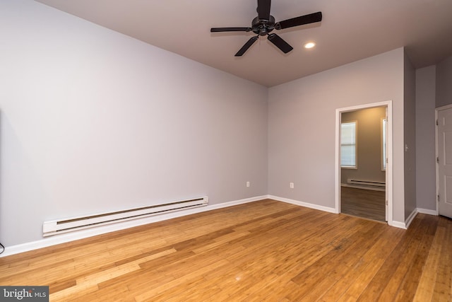 empty room featuring a baseboard heating unit, wood-type flooring, a baseboard radiator, baseboards, and ceiling fan