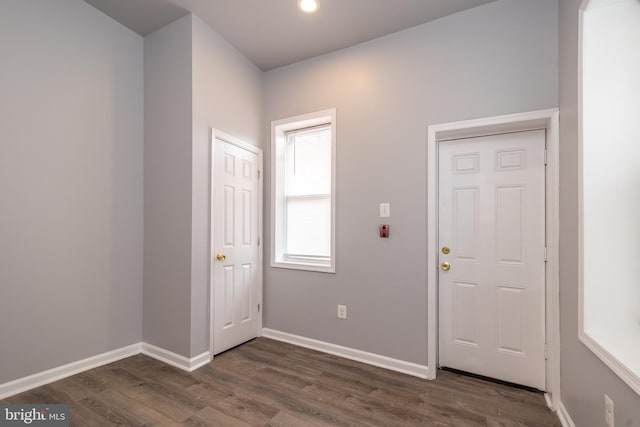 foyer entrance with recessed lighting, baseboards, and dark wood finished floors