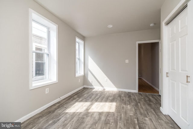 interior space with wood finished floors and baseboards