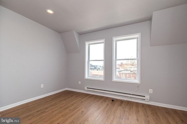 bonus room with recessed lighting, a baseboard heating unit, baseboards, and wood finished floors