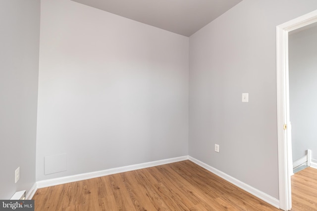 empty room with light wood-style floors and baseboards