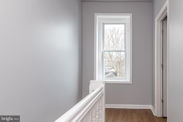 hallway with light wood-style floors and baseboards