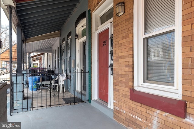 doorway to property with brick siding